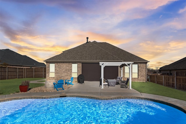 view of swimming pool featuring a patio area, a lawn, and a fenced backyard