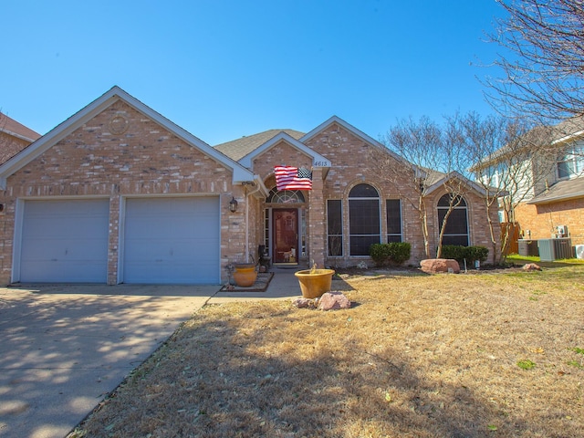 ranch-style house featuring central AC unit, a garage, brick siding, concrete driveway, and a front lawn