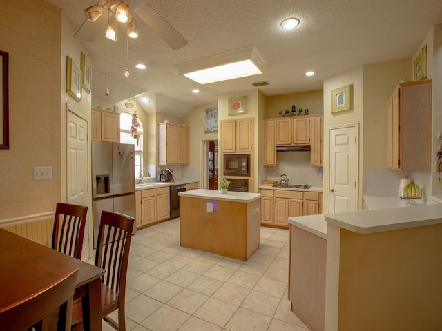 kitchen featuring stainless steel refrigerator with ice dispenser, visible vents, light brown cabinets, a sink, and black microwave