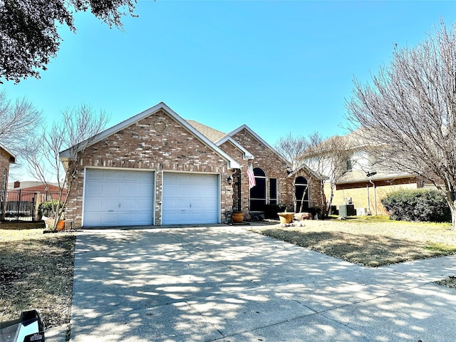 view of front of house with concrete driveway, brick siding, and an attached garage