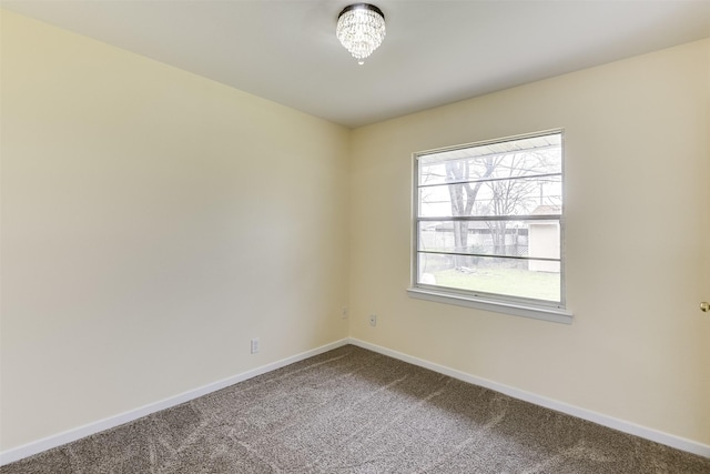 empty room with carpet flooring and baseboards