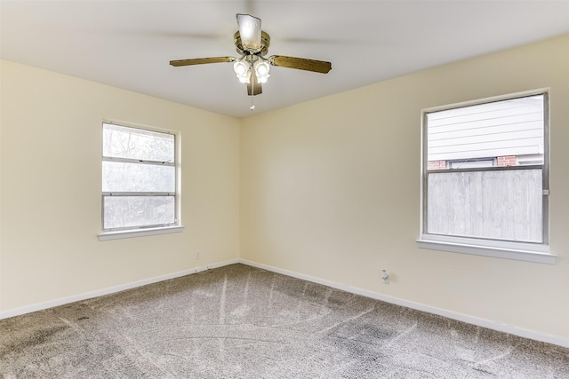 unfurnished room featuring carpet floors, baseboards, and a ceiling fan