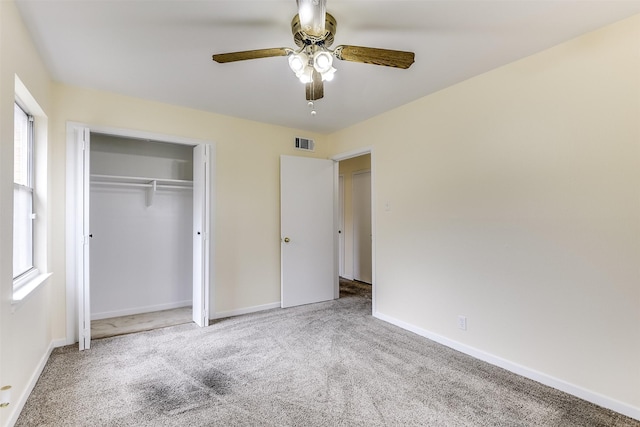 unfurnished bedroom featuring a closet, carpet, visible vents, and baseboards