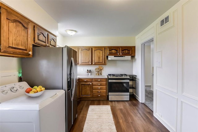 kitchen with stainless steel gas stove, washer / dryer, visible vents, light countertops, and under cabinet range hood