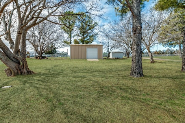 view of yard featuring an outdoor structure and fence