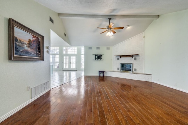 11484 Moran Rd, Azle, TX 76020 - unfurnished living room featuring a ceiling fan, beam ceiling, a fireplace, hardwood / wood-style flooring, and baseboards