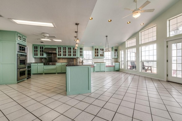 11484 Moran Rd, Azle, TX 76020 - kitchen with green cabinetry, a ceiling fan, ventilation hood, stainless steel appliances, and dark countertops