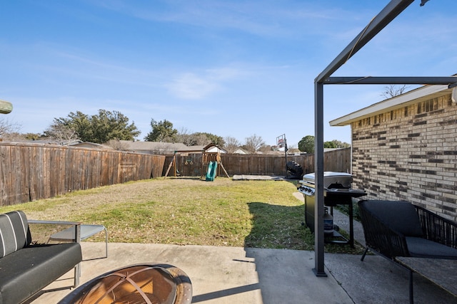 view of yard with a patio area, a fenced backyard, and a playground