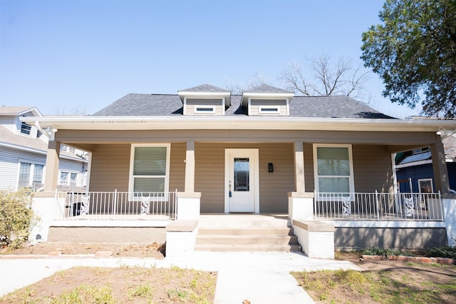 bungalow-style house with covered porch and roof with shingles