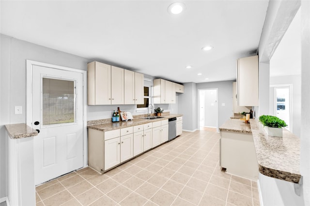 kitchen featuring dishwasher, light tile patterned floors, a sink, and recessed lighting