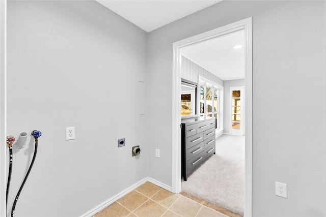 washroom with light tile patterned floors, hookup for a washing machine, laundry area, baseboards, and electric dryer hookup