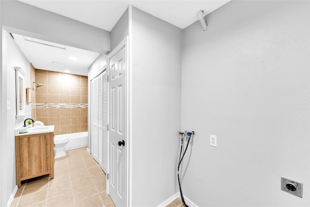 full bath with baseboards, toilet, tile patterned floors, vanity, and shower / washtub combination