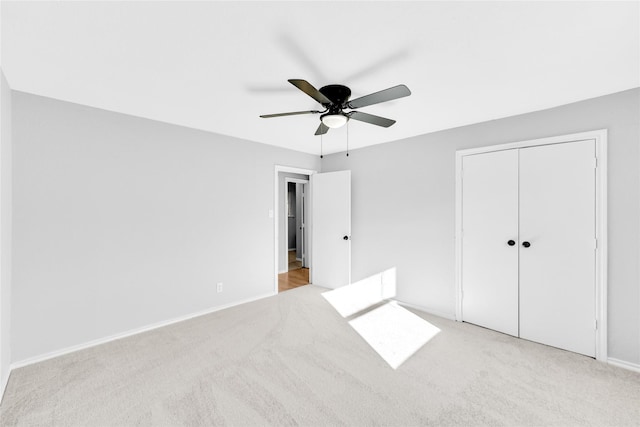 unfurnished bedroom featuring a closet, carpet flooring, and a ceiling fan