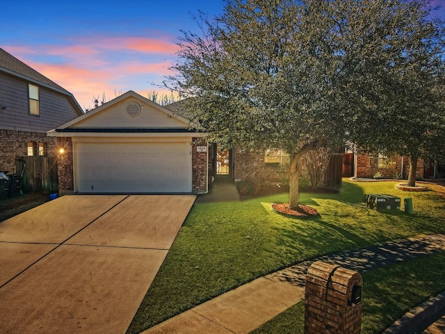 view of front of home featuring a garage, concrete driveway, fence, a front yard, and brick siding