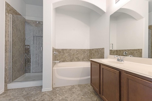 bathroom with a garden tub, a shower stall, and vanity