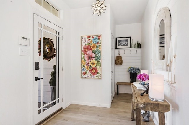 entryway featuring baseboards and light wood-style floors