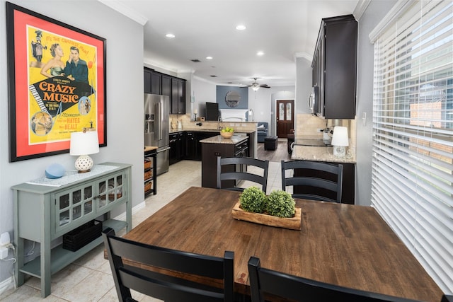 dining area featuring ornamental molding, recessed lighting, a healthy amount of sunlight, and light tile patterned floors