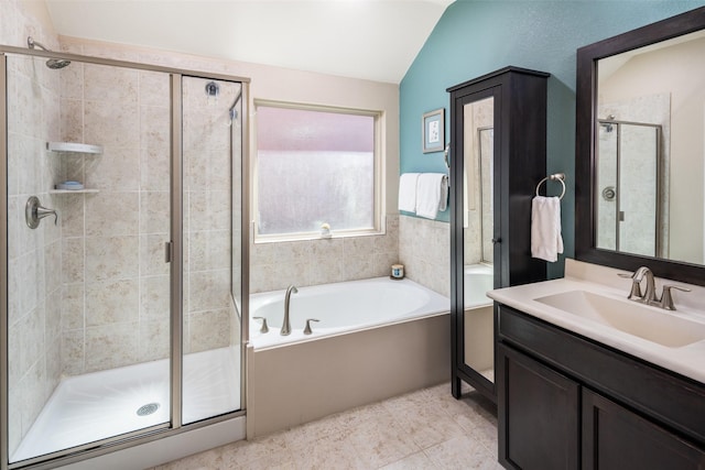 full bath with a stall shower, tile patterned flooring, vaulted ceiling, vanity, and a bath