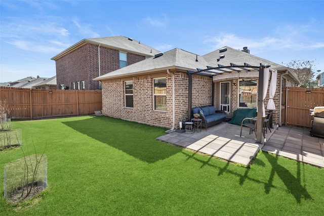 back of property with brick siding, a fenced backyard, a pergola, and a patio