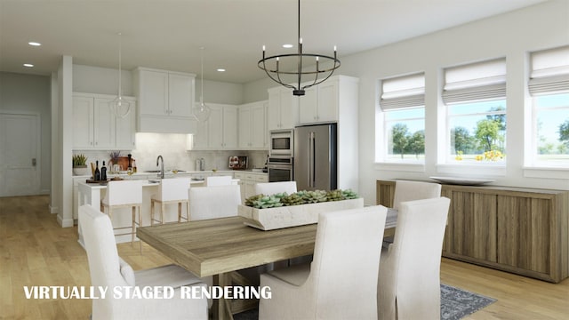 dining room with light wood-style flooring, a notable chandelier, and recessed lighting