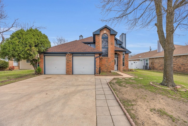 view of front of home featuring brick siding, a chimney, an attached garage, fence, and a front yard