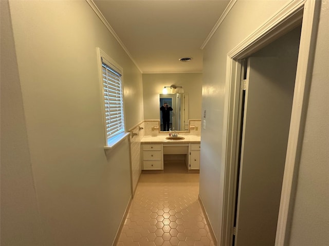 bathroom with visible vents, crown molding, vanity, and tile patterned floors