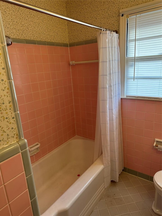 bathroom featuring shower / bath combination with curtain, tile walls, toilet, and tile patterned floors