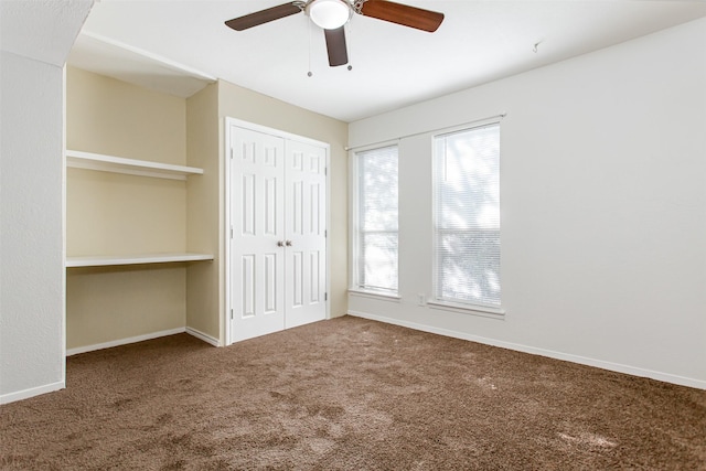 unfurnished bedroom with carpet floors, a closet, a ceiling fan, and baseboards