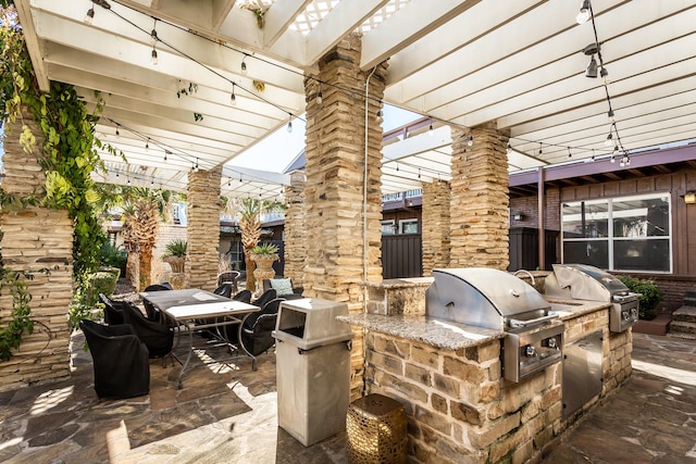 view of patio with outdoor dining space, grilling area, and an outdoor kitchen