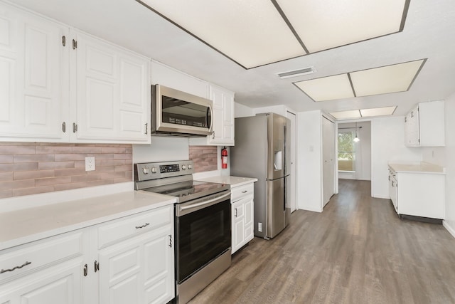 kitchen featuring stainless steel appliances, light countertops, visible vents, and white cabinetry