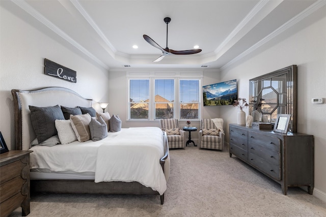 bedroom with carpet floors, visible vents, a tray ceiling, and ornamental molding