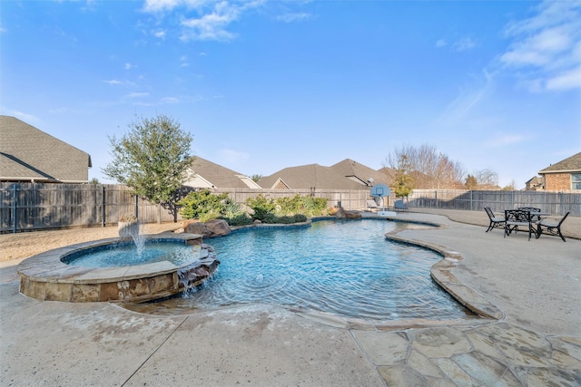 view of pool featuring a patio area, a fenced backyard, and a pool with connected hot tub