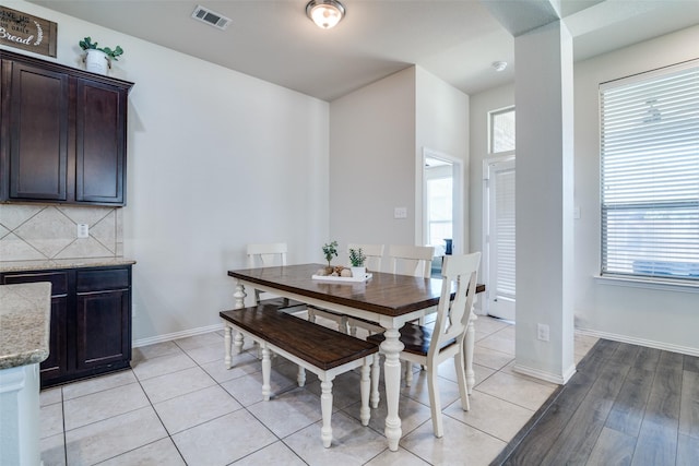 dining area with a healthy amount of sunlight, visible vents, baseboards, and light tile patterned floors