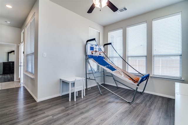 game room featuring visible vents, ceiling fan, baseboards, and wood finished floors