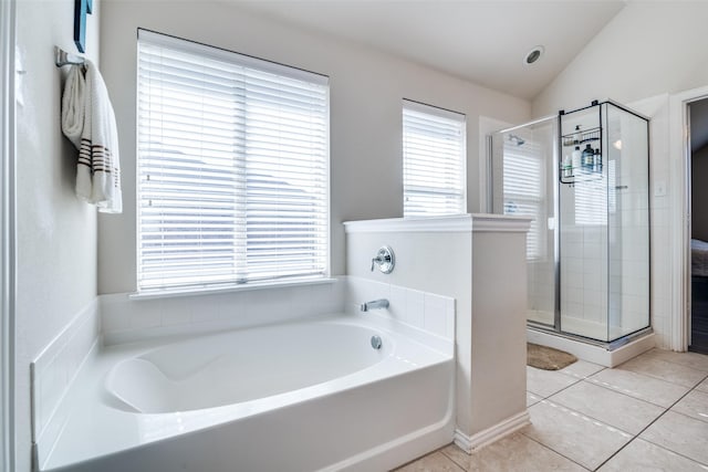 full bathroom with lofted ceiling, tile patterned flooring, a shower stall, and a bath