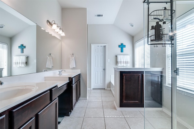 bathroom featuring lofted ceiling, tile patterned flooring, visible vents, and a sink