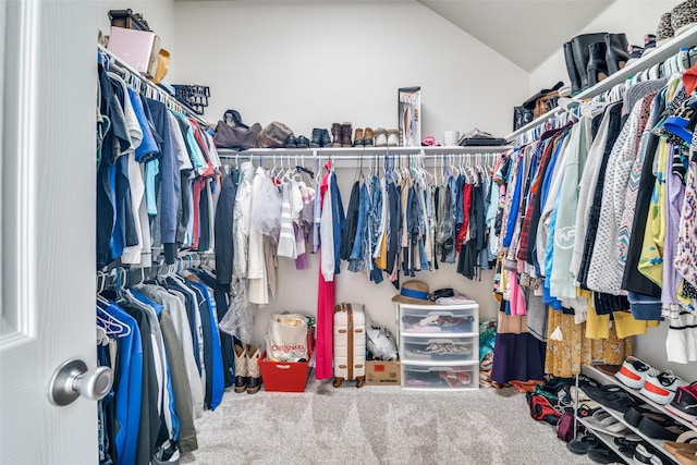 spacious closet featuring vaulted ceiling and carpet flooring