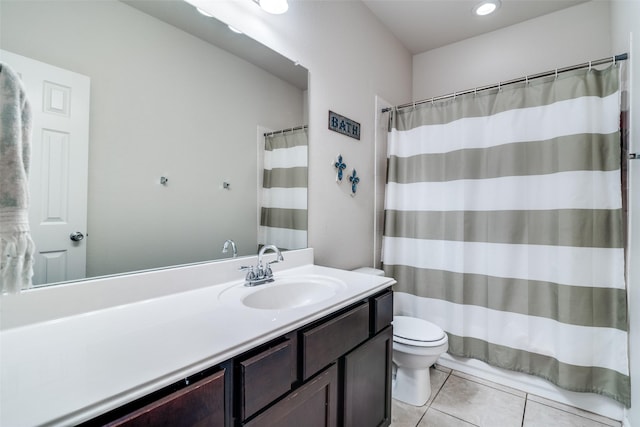 bathroom with a shower with curtain, vanity, toilet, and tile patterned floors