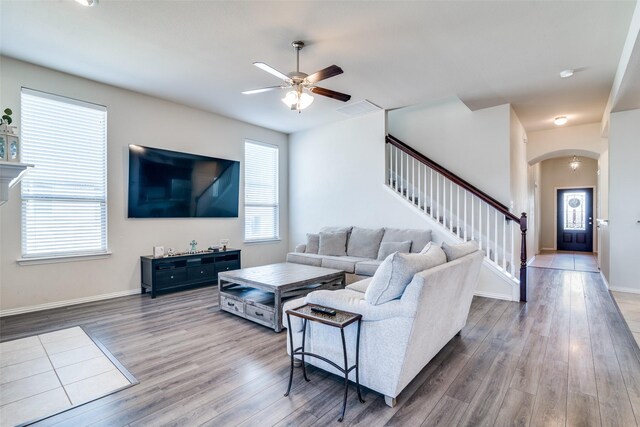 living room featuring a wealth of natural light, visible vents, and wood finished floors