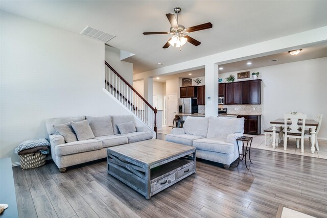 kitchen featuring light stone counters, tasteful backsplash, visible vents, appliances with stainless steel finishes, and light tile patterned flooring