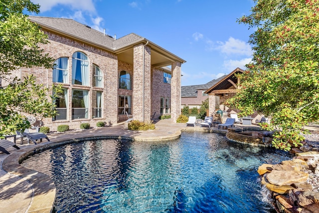 view of pool with a pool with connected hot tub and a patio area