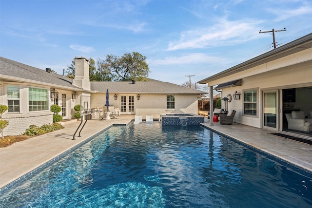 view of pool featuring french doors, a patio area, fence, and a pool with connected hot tub