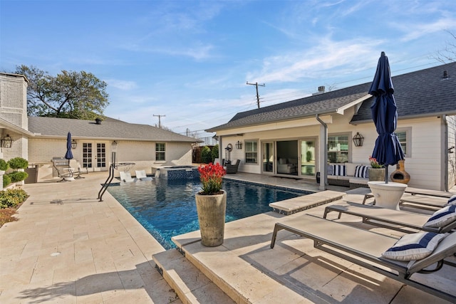 outdoor pool with an outbuilding, a patio, outdoor lounge area, french doors, and an exterior structure