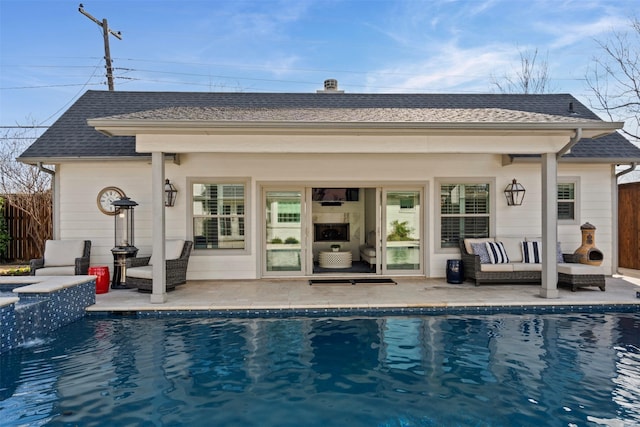 back of house featuring a fenced in pool, roof with shingles, a patio, and outdoor lounge area