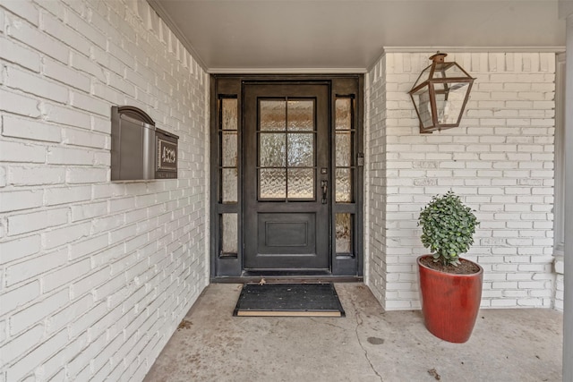 view of exterior entry with brick siding