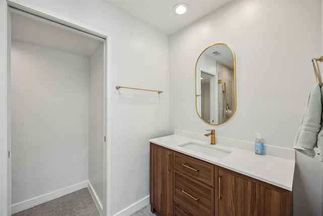 bathroom featuring recessed lighting, baseboards, and vanity