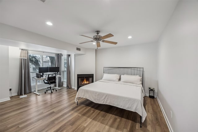 bedroom with recessed lighting, ceiling fan, baseboards, and wood finished floors