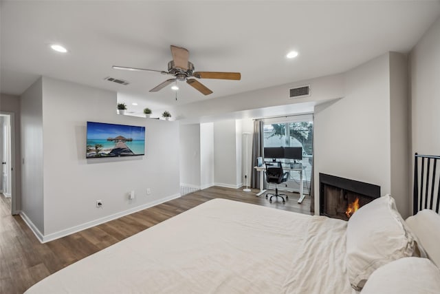 bedroom featuring wood finished floors, visible vents, and recessed lighting