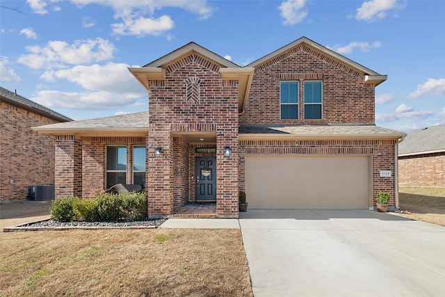 traditional home featuring driveway, an attached garage, central AC unit, and brick siding