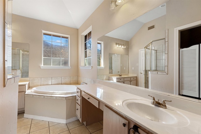 bathroom featuring lofted ceiling, a garden tub, visible vents, tile patterned floors, and a stall shower